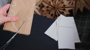 Master class of making craft paper snowflakes for conscientious Christmas decor. Sustainable celebration minimal responsible DIY holiday project. Step by step instruction video