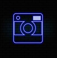 Glowing neon line Photo camera icon isolated on brick wall background. Foto camera icon. Colorful outline vector