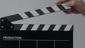 Close up hand holding empty film slate and clapping in front of camera. video