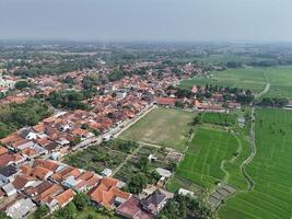 aerial view of a village in the countryside. rice fields around the village. photo