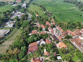aerial view of a village in the countryside. rice fields around the village. photo