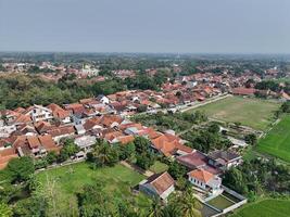 aerial view of a village in the countryside. rice fields around the village. photo