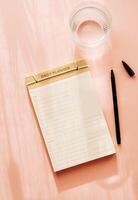 Flat lay minimalist daily planner with a simple design, featuring checkboxes and lines for tasks photo