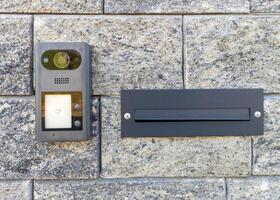 Modern intercom and mailbox on brick wall photo