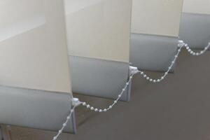 Modern vertical fabric blinds on the window in the office photo