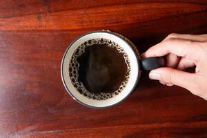 Top View of Coffee Mug on Wooden Table photo