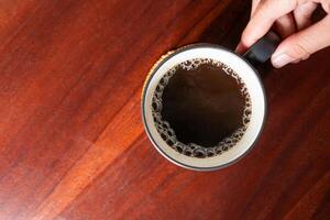Top View of Coffee Mug on Wooden Table photo