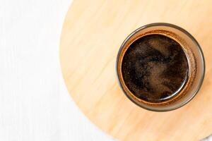 Glass of Black Coffee with Frothy Cream photo