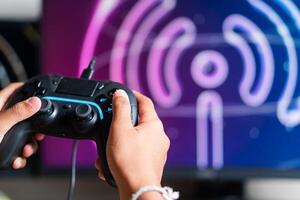 Gaming with Wireless Controller and Neon Wu-F Symbol photo
