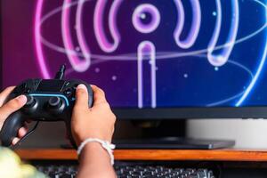 Gaming with Wireless Controller and Neon Wu-F Symbol photo
