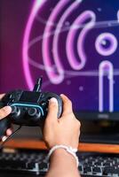 Gaming with Wireless Controller and Neon Wu-F Symbol photo