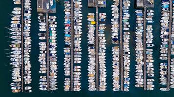 Aerial view of a marina filled with rows of docked boats, showcasing a stunning pattern of vessels against the deep blue water. Port of Marseille, France photo