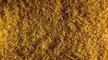 Background of Uncooked Noodles that Slowly Rotating Counterclockwise - Top View. Texture of Dry Vermicelli Turning Around. Raw Pasta with Low Key Light - Left Rotation video