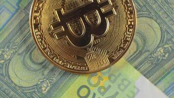 Bitcoin Coins on the 100 Euro Banknotes - Top View, Macro. Euro Money Cash and Cryptocurrency. Hundred Euro Bills. Finances, Exchange, Blockchain and Electronic Money Concept - Slow Rotation Left video