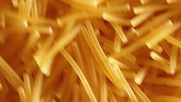 Background of Uncooked Noodles Rotating Counter-Clockwise - Top View, Angular Rotation, Close-Up. Texture of Dry Vermicelli Turning Around. Raw Pasta with Low Key Light - Left Rotation video
