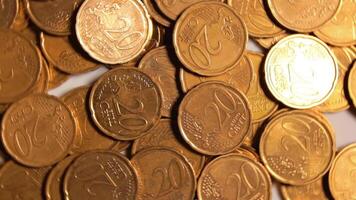 Scattered 20 Euro Cent Coins, Rotating Money Background - Top View. Euro Money Currency. A Lot of Twenty Cent Cash. Golden Eurocents. Business, Finances and Money Saving Concept - Slow Rotation Right video