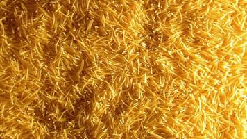 Background of Uncooked Noodles that Slowly Rotating Clockwise - Top View. Texture of Dry Vermicelli Turning Around. Raw Pasta with Low Key Light - Right Rotation video