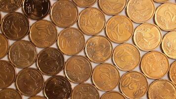 20 Euro Cent Coins, Rotating Money Background - Top View. Euro Money Currency. A Lot of Twenty Cent Cash. Golden Eurocents. Business, Finances and Money Saving Concept - Slow Rotation Left video
