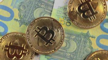 Bitcoin Coins on the 100 Euro Banknotes - Top View. Euro Money Cash and Cryptocurrency. Hundred Euro Bills. Finances, Exchange, Blockchain and Electronic Money Concept - Rotation Left video