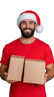 Smiling man in Santa hat holding two cardboard boxes in red shirt on transparent background png