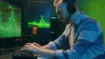 Tired Caucasian man worker analyst type keyboard computer pc software sleepless programmer yawning online male work late night crypto trade guy deadline at home green neon multiple screens exhaustion video
