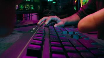 Close up hands man unrecognizable male typing gamer streamer hacker programmer desktop computer code data keyboard work cyber sport addiction play game neon light studio pc mouse networks guy video