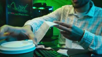 Caucasian focused man programmer checking coding guy coder male professional digital engineer IT support drinking coffee typing working on desktop computer creating Innovative software developing app video