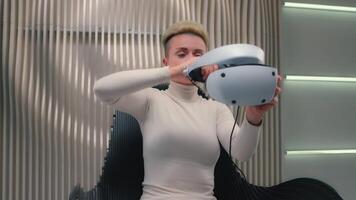 Caucasian woman female gamer girl player wearing gaming VR helmet 3d glasses play virtual augmented reality simulation modern cyber technology neon futuristic metaverse playing addict AR cyberspace video