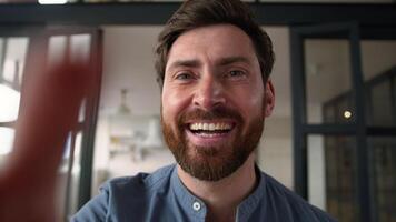 Smartphone point of view carefree Caucasian man male dad father swipe screen POV webcam smiling guy laugh scrolling feed on social media apps mobile phone at home ordering delivery playing game video