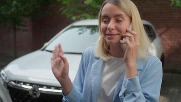 Carefree Caucasian female girl transport driver smiling woman talking mobile phone smartphone glad businesswoman discussing car purchasing in city buy new automobile rent auto insurance communication video