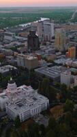Modern architecture of Sacramento downtown in the evening. River and green landscape at backdrop. Top view. Vertical video