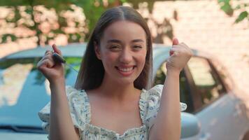 Overjoyed happy smiling Caucasian woman female owner buyer client girl looking at camera funny gesturing clenching fists showing keys celebrating achievement buy car rent automobile transport at city video