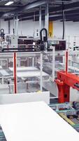 Industrial robot working in factor. Manufacturing of solar panels in factory Vertical video