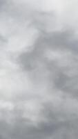 Dramatic cloudscape forming in the skies. Rainy clouds move in the atmosphere. Low angle view. Timelapse. Vertical video