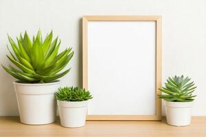 Minimalist poster frame with small plants on a wooden floor in soft ambient light photo