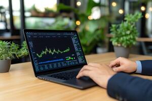 Middle-aged man in dark suit analyzing financial performance data on laptop in modern office setting photo