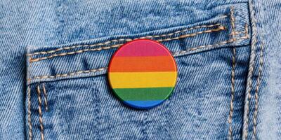 Bright rainbow election badge on a denim jacket promoting inclusivity and support for diversity in a community event photo