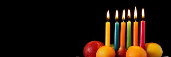Elegant Kwanzaa kinara setup with seven colorful candles and vibrant fruits on a black background photo