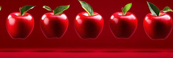 Bright red apples bouncing in mid-air against a deep red background showcasing their glossy texture and vivid color photo
