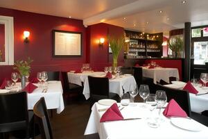 Cozy restaurant corner with elegant dark red decor and soft lighting creating a sophisticated dining ambiance photo
