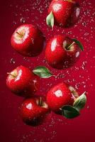 Bright red apples bouncing in mid-air against a deep red background showcasing vivid colors and glossy texture photo