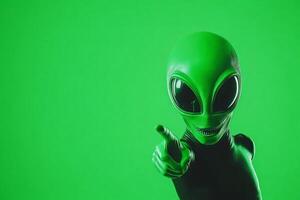 Playful green alien pointing at the viewer against a bold neon green background for a whimsical touch photo