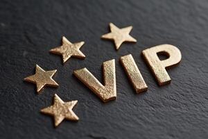 Elegant VIP sign in bold gold letters with surrounding stars on a textured dark background for luxury events photo