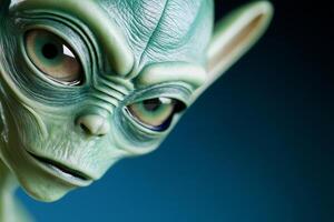 Close-up view of a mysterious alien face with dark features and unique green skin under dim lighting photo
