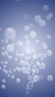 A stream of smooth shiny spheres flowing towards the camera against a blue gradient background. This clean modern motion design is full HD and a loop. Vertical animation. video