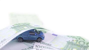 Model car with euro banknotes on white background concept of saving for buying car, car loan and car insurance. photo
