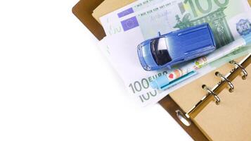Model car with euro banknotes on white background concept of saving for buying car, car loan and car insurance. photo