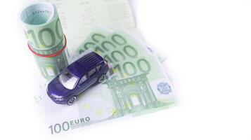 Model car with euro banknotes on white background concept of saving for buying car, car loan and car insurance. photo
