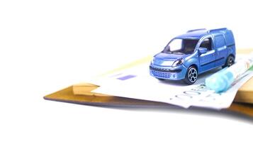 Model car with euro banknotes on white background concept of saving for buying car, car loan and car insurance. photo