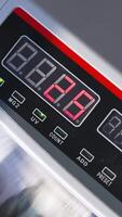 Electronic cash counting equipment working. Unrecognized banknotes turning quickly in machine. Close up. Vertical video